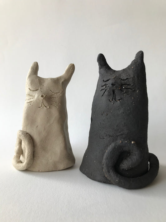 Hand-made cute black and white cats in studio ceramic studio Leera